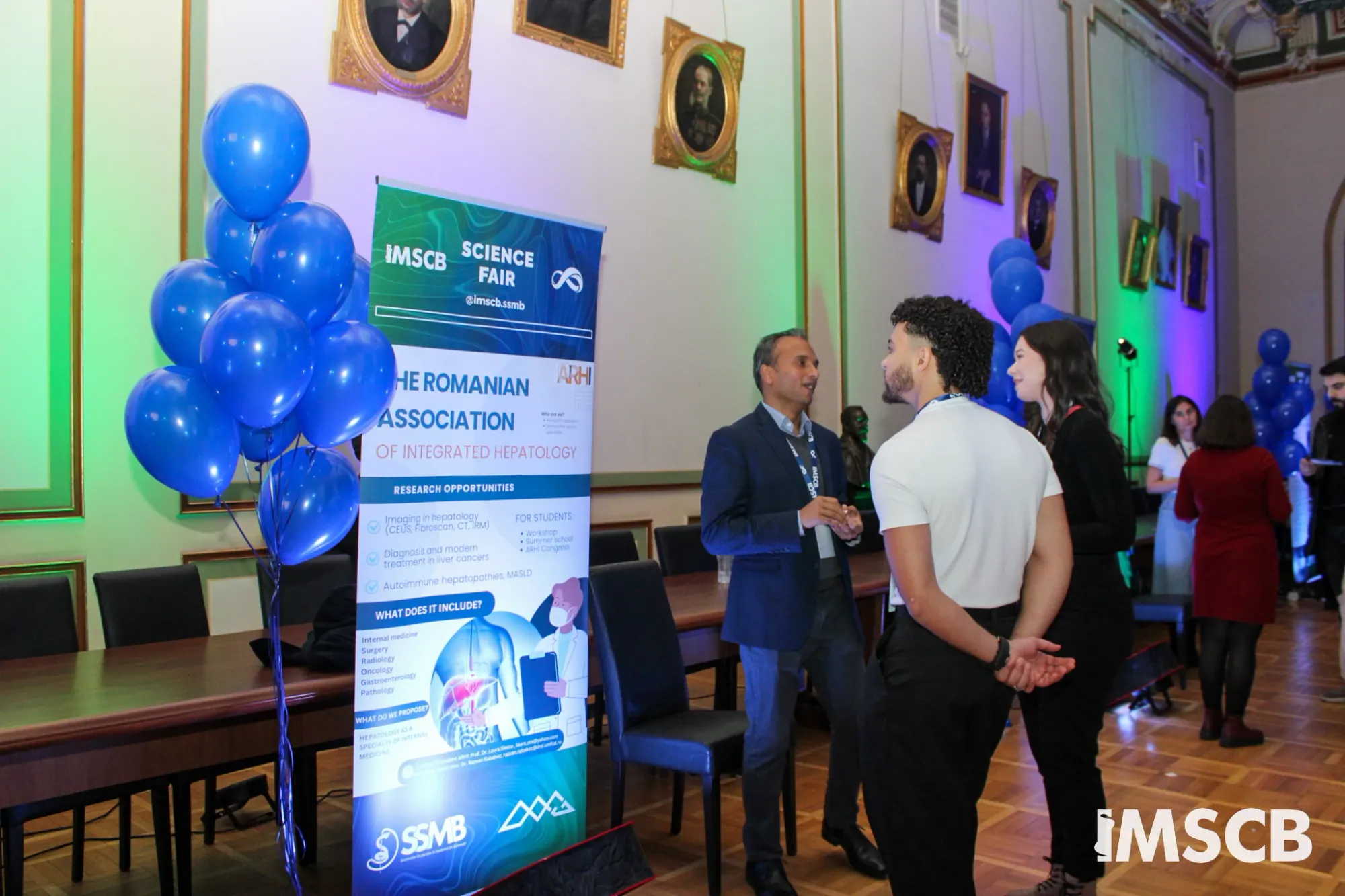 Researchers talking with students at the Science Fair